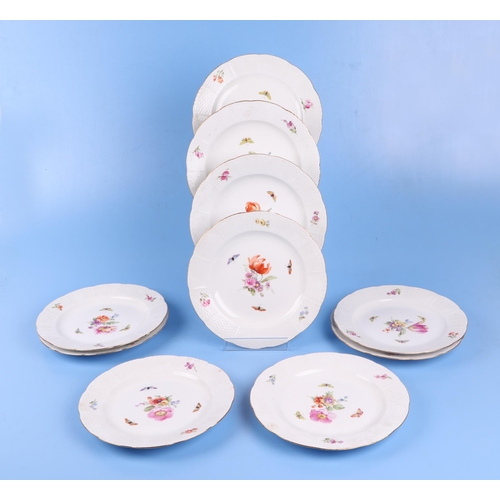 767 - A quantity of KPM Berlin porcelain decorated with flowers and butterflies to include dinner plates a... 