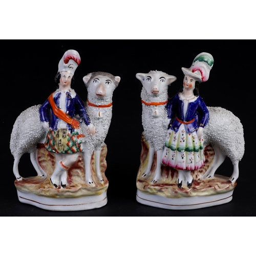 774 - A pair of 19th century Staffordshire figures, Highlanders with large sheep, 20cms high (2).