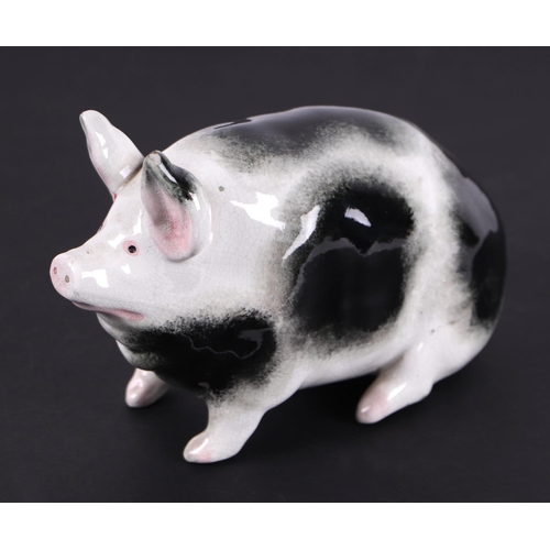 780 - A Wemyss pottery pig seated on its haunches painted with black sponged markings and pink ears, impre... 