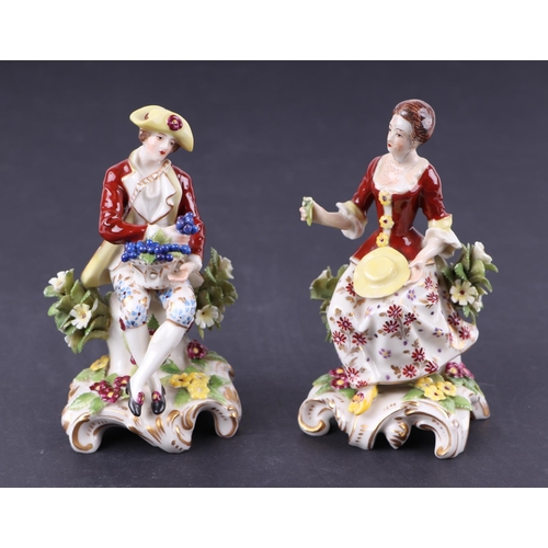 782 - A pair of Chelsea style porcelain figures depicting a seated lady and gentleman, each approx 13cms h... 