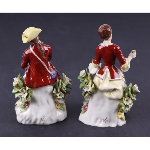 782 - A pair of Chelsea style porcelain figures depicting a seated lady and gentleman, each approx 13cms h... 