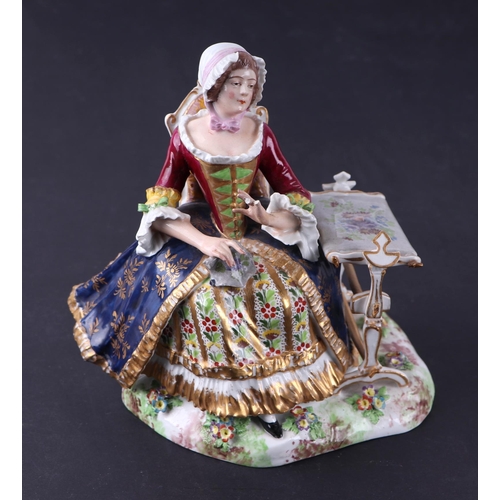 784 - A Crown Derby group depicting a lady seated next to a table, 15cms wide.