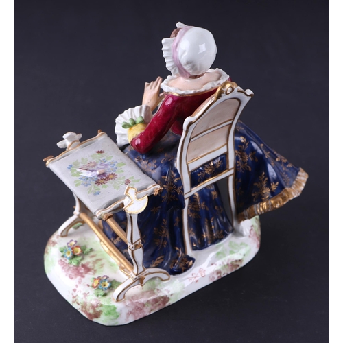 784 - A Crown Derby group depicting a lady seated next to a table, 15cms wide.