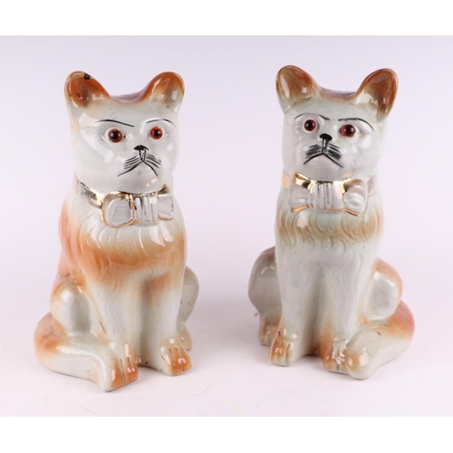 785 - A pair of Staffordshire cat figures with glass eyes and gilt highlight decoration, each 32cms high (... 