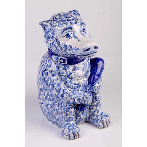 788 - A Delft blue and white tobacco jar and cover, in the form of a seated bear holding a club with armor... 