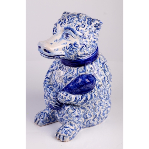 788 - A Delft blue and white tobacco jar and cover, in the form of a seated bear holding a club with armor... 