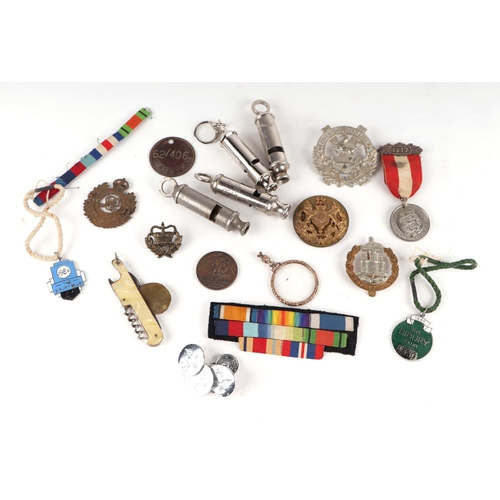 840 - A quantity of cap badges, medal ribbons, whistles and other items