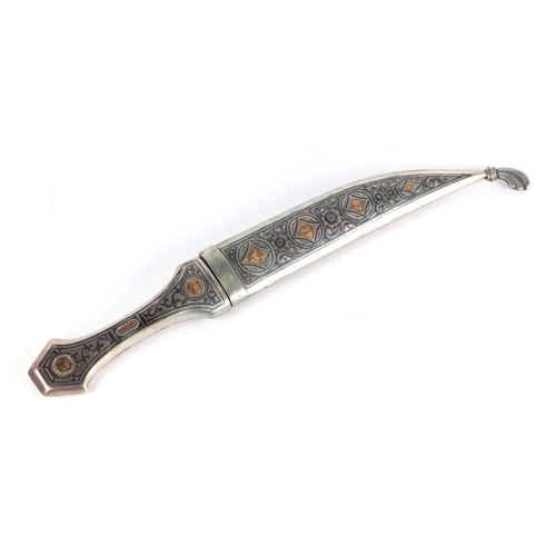 89 - An Iraqi Marsh Arab white metal (silver) niello and yellow metal inlaid dagger, 33cms long