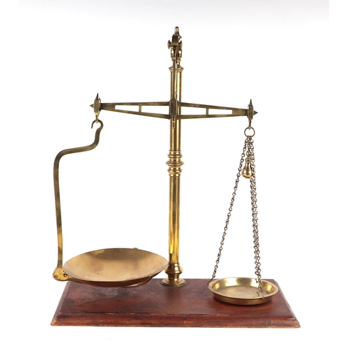 890 - A set of Victorian style brass shop scales, 50cms wide.