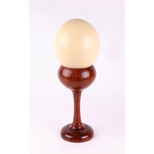 895 - Taxidermy - An ostrich egg on a turned wooden stand.