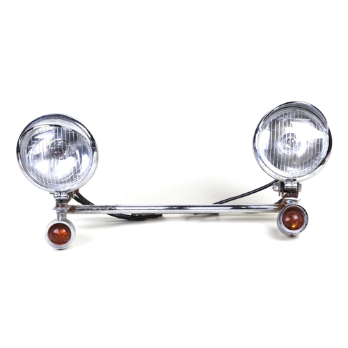 958 - A vintage motor scooter chrome light bar with a pair of headlights and indicators.