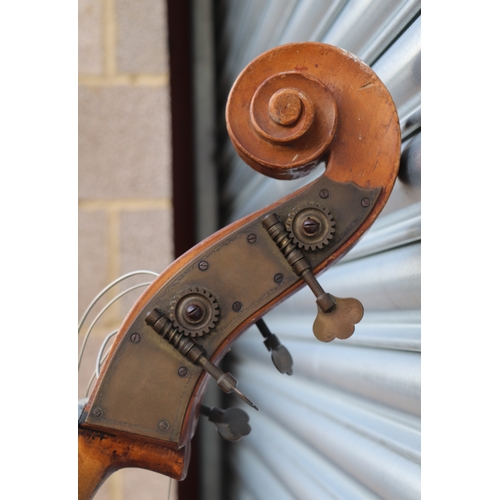 860 - A double bass with single piece back, ebony finger board and heavily carved scroll with brass plates... 