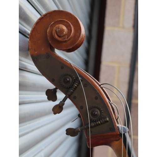 860 - A double bass with single piece back, ebony finger board and heavily carved scroll with brass plates... 