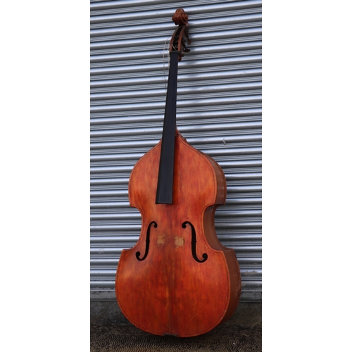 860 - A double bass with single piece back, ebony finger board and heavily carved scroll with brass plates... 