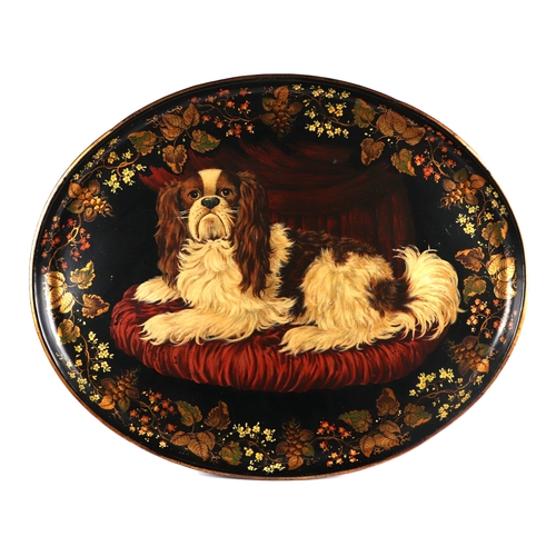 287 - An 18th century style toleware metal tray decorated with a King Charles spaniel, 75cms wide.