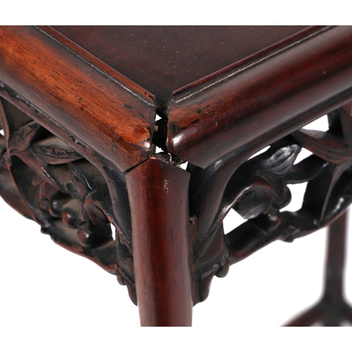 667 - A nest of four Chinese rosewood tables with ornate carved and pierced freeze, largest 52cm wide.