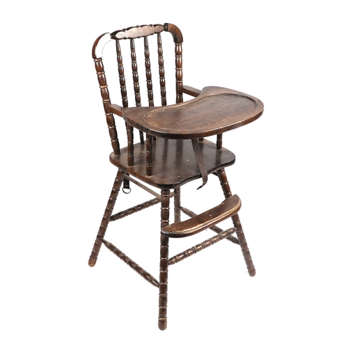 2026 - An early 20th century child's stained beech high chair on bobbin turned supports.