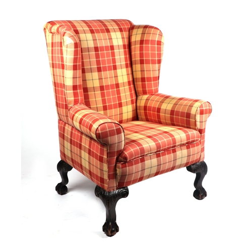 2068 - A George III style upholstered wing armchair on ball & claw feet.