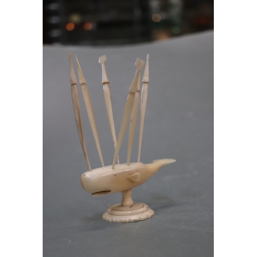 1569 - Folk Art:  A carved marine ivory sperm whale toothpick holder in the form of a whale mounted on a pl... 