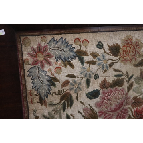 1367 - A needlework tapestry panel depicting flowers and foliage, 49 by 57cms, in a rosewood frame.