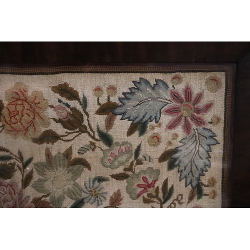 1367 - A needlework tapestry panel depicting flowers and foliage, 49 by 57cms, in a rosewood frame.