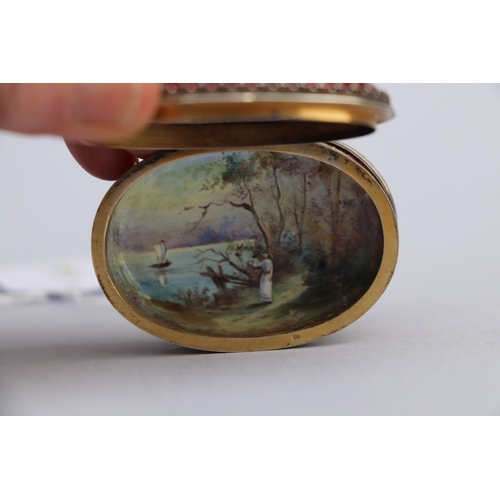 1567 - A continental (Austrian) oval enamel box decorated with figures and landscapes within panels with gi... 