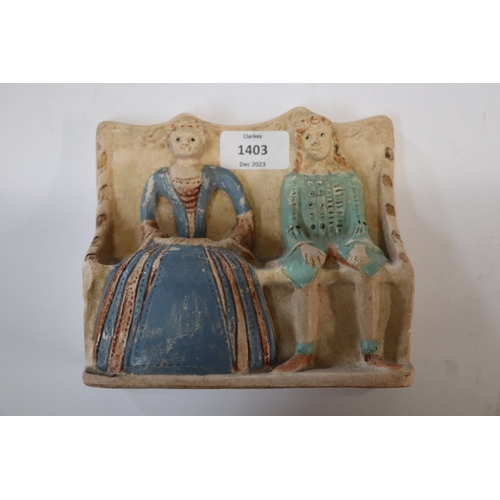 1403 - A flat back pottery group depicting an Elizabethan couple seated on a settle, possibly Compton Potte... 