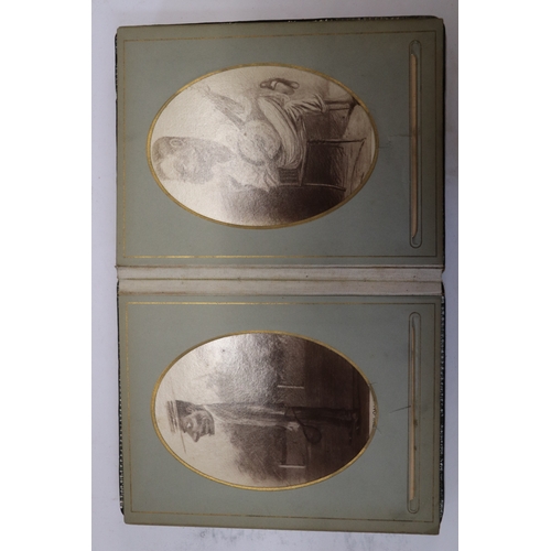 750 - A late Victorian Indian photograph album containing photographic postcards depicting caricatures of ... 