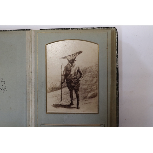 750 - A late Victorian Indian photograph album containing photographic postcards depicting caricatures of ... 