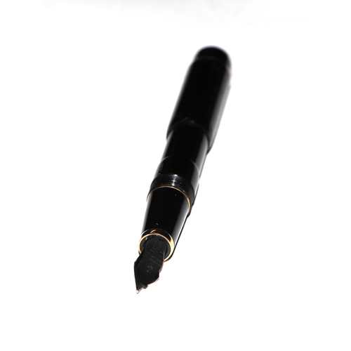 1033 - A black lacquer and gilt metal fountain pen with iridium point nib, 13cms long.