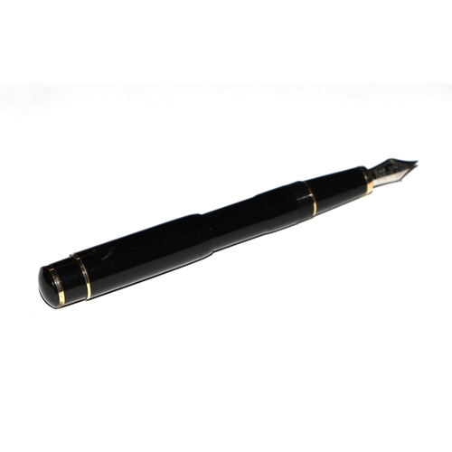 1033 - A black lacquer and gilt metal fountain pen with iridium point nib, 13cms long.