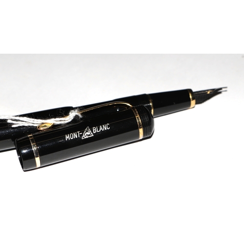 1033 - A black lacquer and gilt metal fountain pen with iridium point nib, 13cms long.