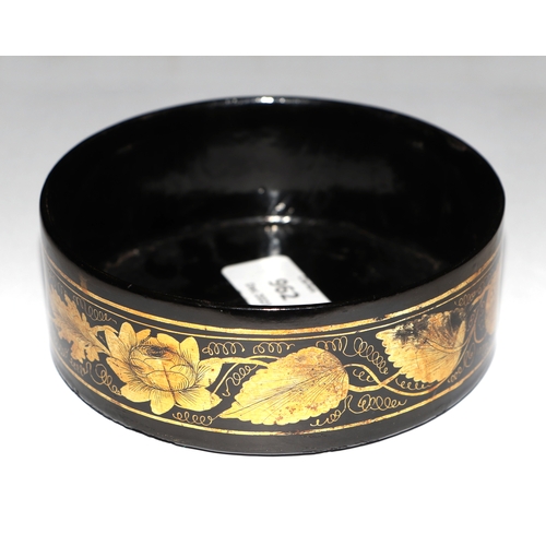 962 - A 19th century Regency papier-mâché wine coaster with gilt leaf decoration, 13cms diameter.