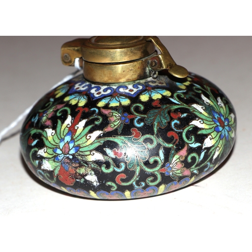 1961 - A Chinese cloisonné scholars inkwell, decorated flowers on a black ground, 9cm diameter