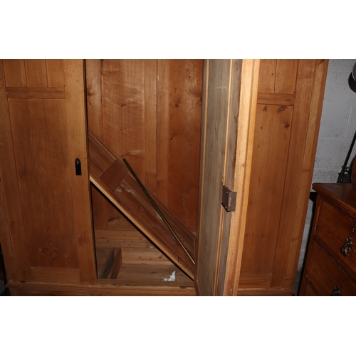 2002 - A Continental pine triple wardrobe with three drawers to the base and fitted interior, 164cm wide