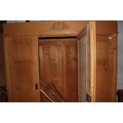 2002 - A Continental pine triple wardrobe with three drawers to the base and fitted interior, 164cm wide