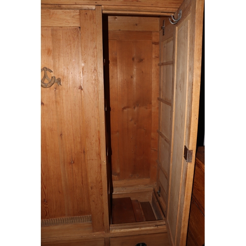 2002 - A Continental pine triple wardrobe with three drawers to the base and fitted interior, 164cm wide