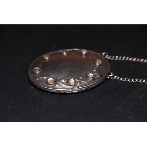 397 - A Victorian silver and moonstone locket on chain, marks rubbed and indistinct, 33g.