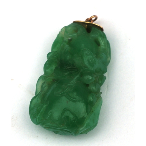 A fine Chinese green jade double gourd pendant carved with a squirrel ...