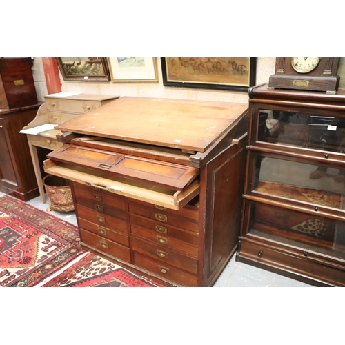 2065 - A 19th century pine and mahogany architect's desk, the sloped top above a lift-up door containing a ... 