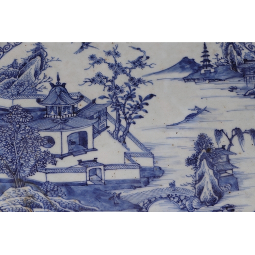 639 - A large 18th century Chinese blue & white oval meat plate decorated with a river landscape scene, 39... 