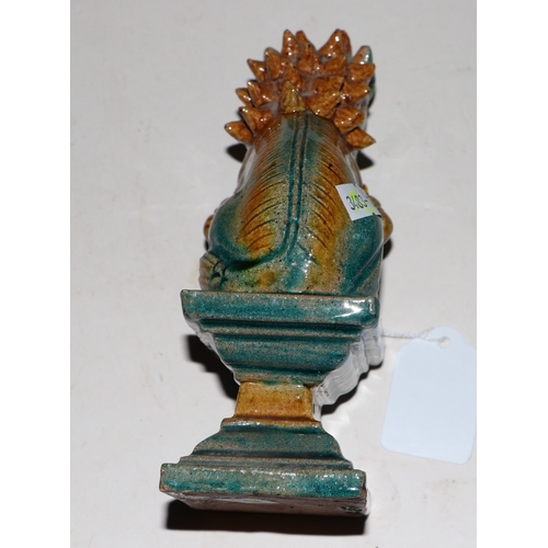 1981 - A pair of Chinese glazed temple lions seated on plinths, 16cms high (2).