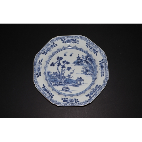 635 - A pair of 19th century Chinese blue & white plates of octagonal form decorated with a river landscap... 