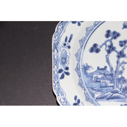 635 - A pair of 19th century Chinese blue & white plates of octagonal form decorated with a river landscap... 