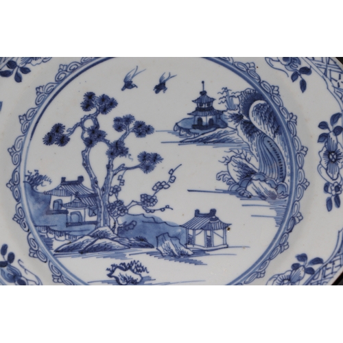 635 - A pair of 19th century Chinese blue & white plates of octagonal form decorated with a river landscap... 