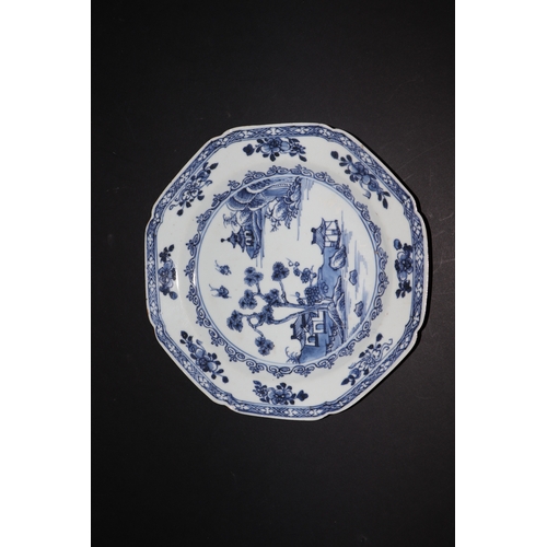 635 - A pair of 19th century Chinese blue & white plates of octagonal form decorated with a river landscap... 