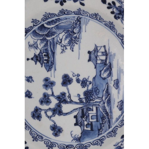 635 - A pair of 19th century Chinese blue & white plates of octagonal form decorated with a river landscap... 