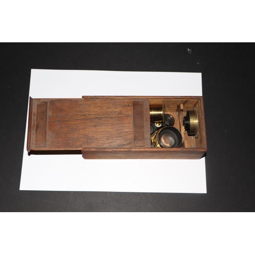 1494 - A late Victorian brass binocular microscope by Charles Collins, cased, with various objectives, eyep... 