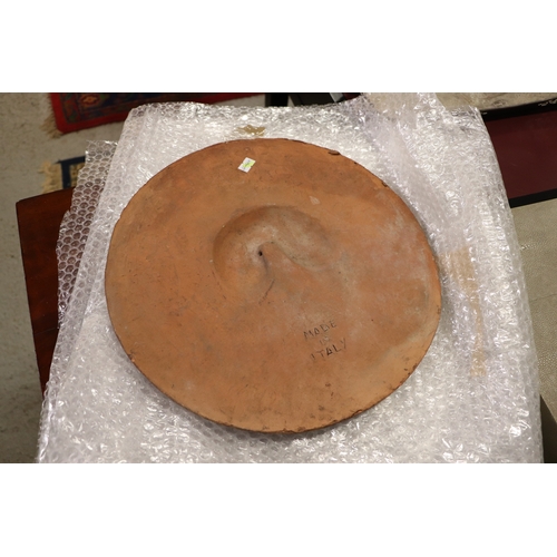 7 - An Italian terracotta sun face wall plaque, 35cm diameter