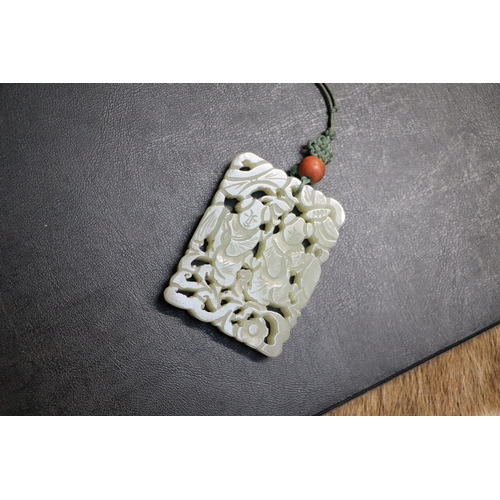 1982 - A Chinese pierced jade pendant, 5 by 6.5cms.